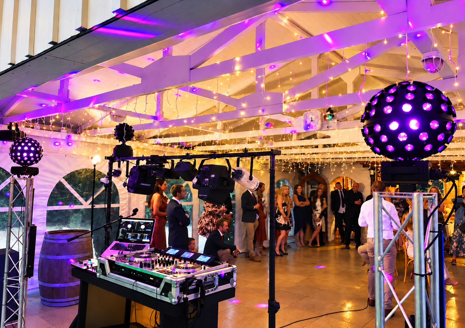 DJ decks, lighting rig and violet disco lights set up at a venue